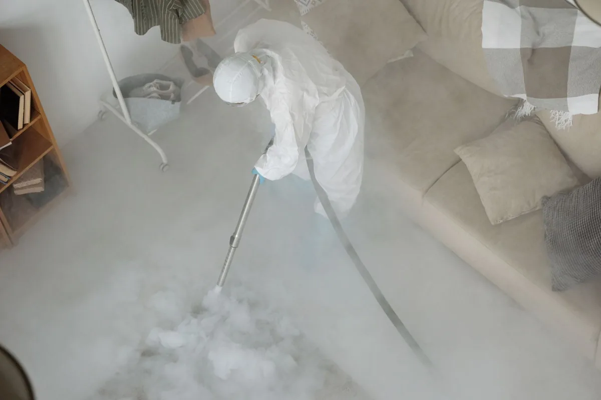 Biohazard cleanup technician in protective equipment, Pinehurst, TX